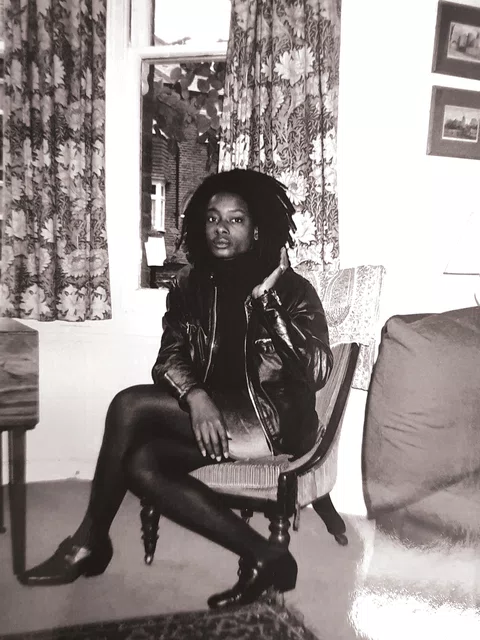 A black and white photo of Marcia Carr sitting down in the '90s
