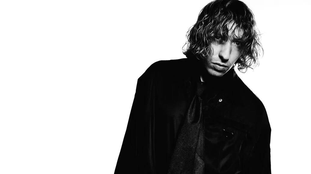 A black and white image of Daniel Avery in a black jacket, looking down to the right