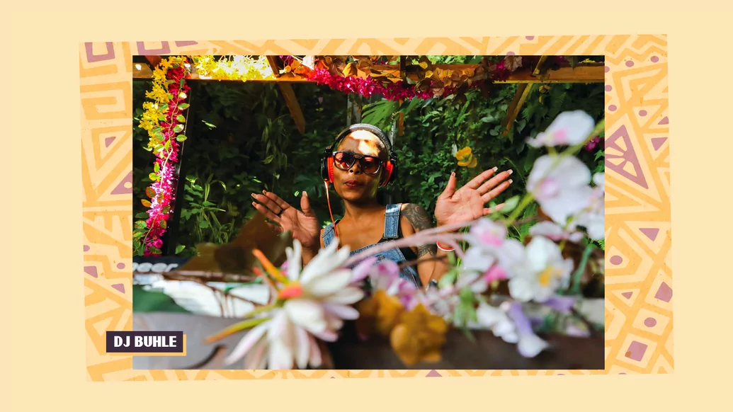Duhle DJing amongst some flowers, hands open in a dancing motion by her head,