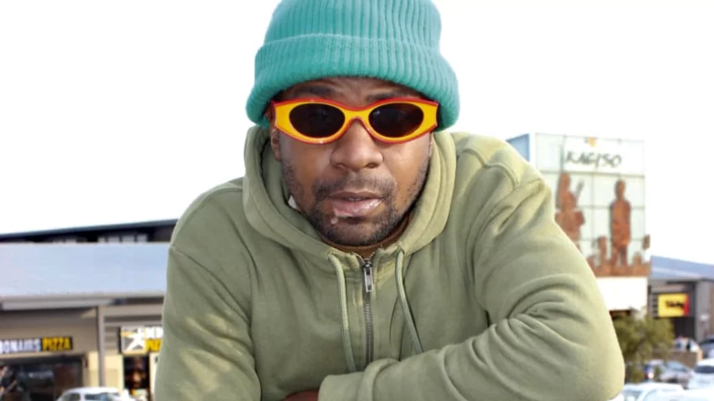 Photo of BNinjas wearing a blue beanie and yellow-rimmed glasses while posing in a carpark
