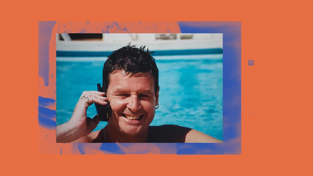 Tony De Vit smiling in a swimming pool holding a phone to his ear