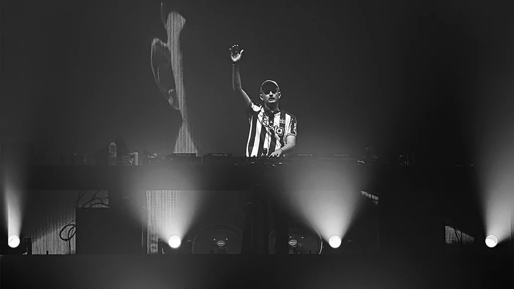 Black and white photo of Ben Hemsley DJing while wearing a Newcastle FC shirt