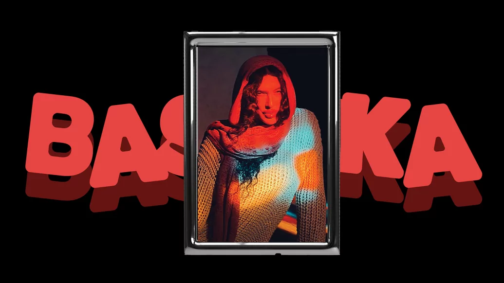 Photo of BASHKKA in a chrome frame with her name written in red behind it