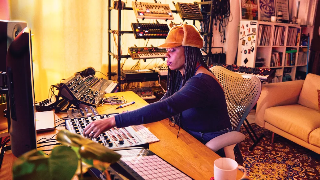 A photo of Carista operating a sound desk in a studio