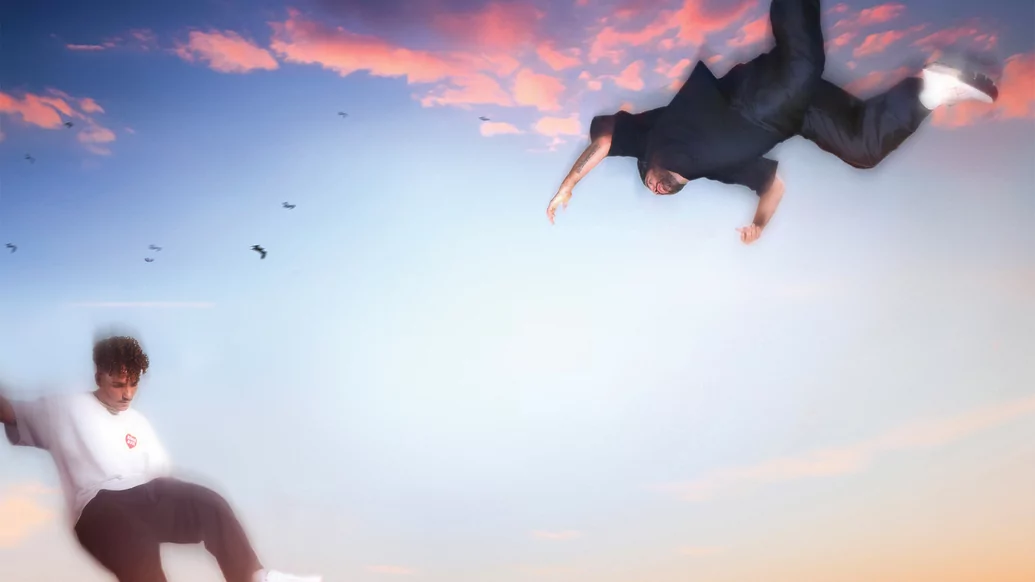 Photo of ANOTR seemingly flying through the air against a sunset background