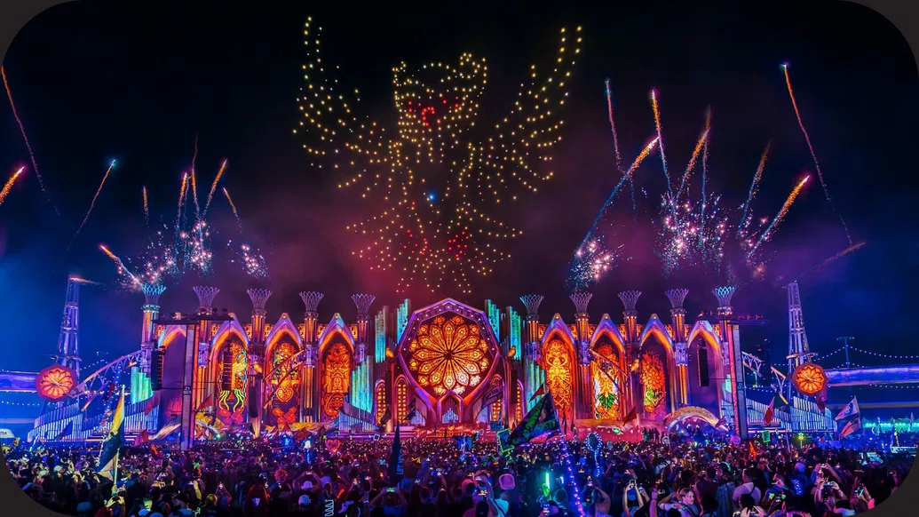 Photo of the main stage at EDC Las Vegas beneath a colourful drone show