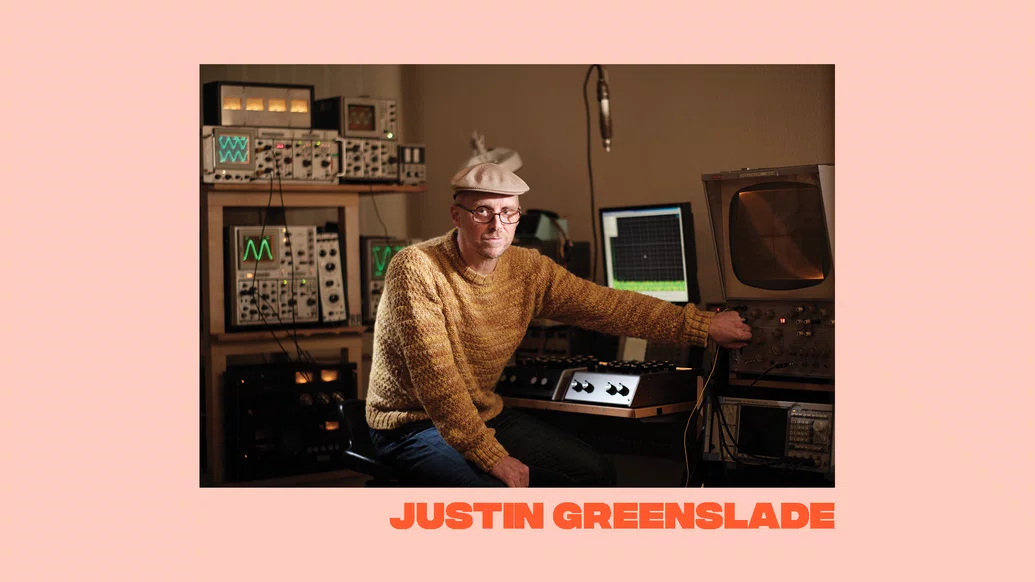 Photo of Justin Greenslade on a peach-coloured background