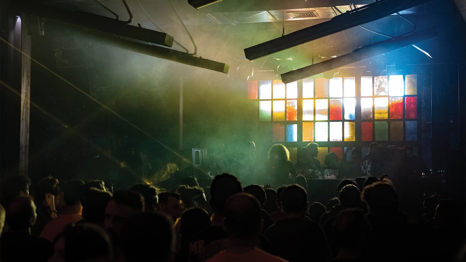 Inside The Grand Factory during a club night with light shining through stained glass windows