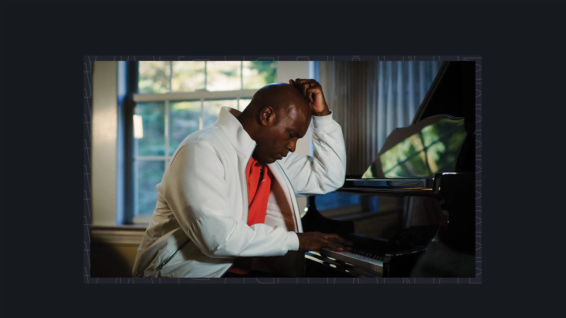 Image of Kelly G playing a piano with a black border. 