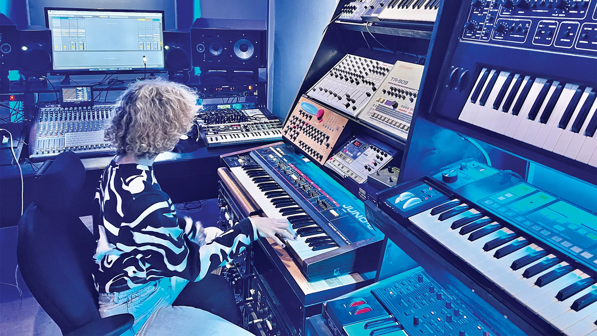 Tigerbalm producing in a blue-lit studio.