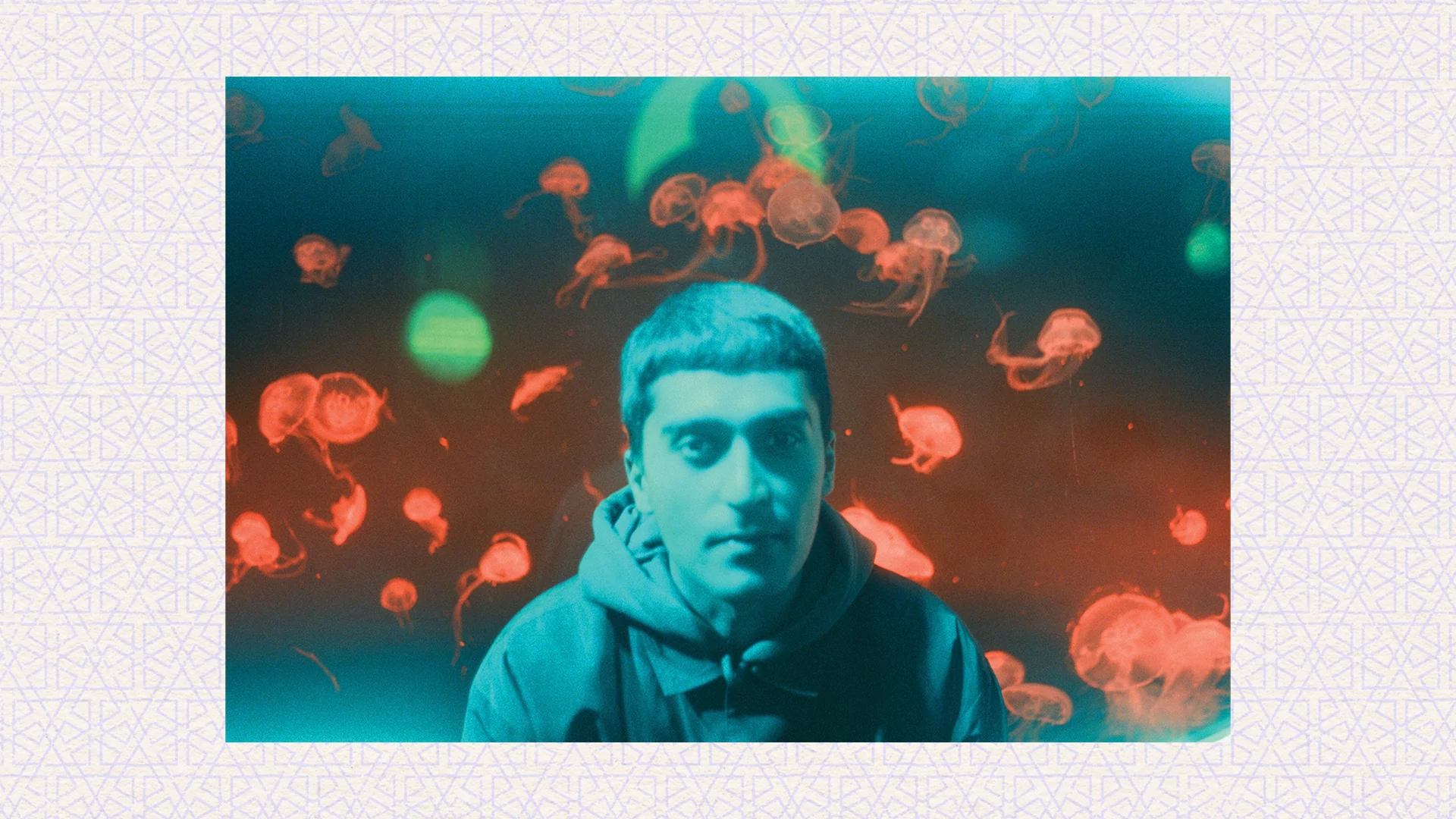 Orange and blue photo of Kasra V with jellyfishes behind him on a cream background