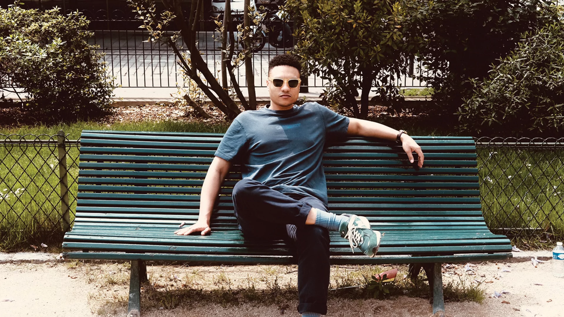 Groovy D sitting on a green park bench