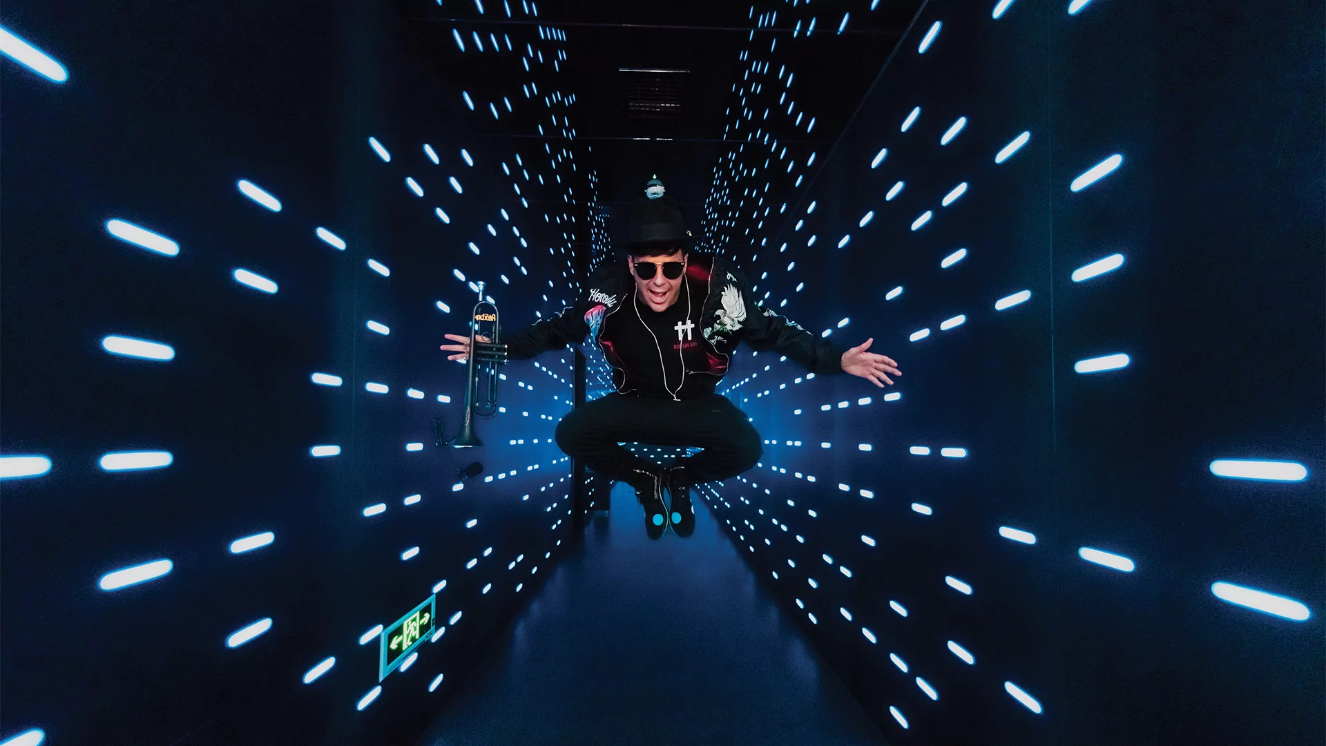 Photo of Timmy Trumpet in a blue-lit hallway