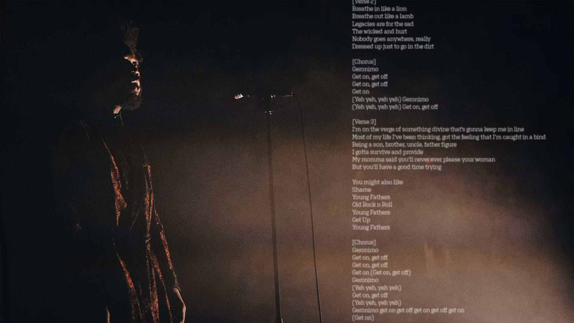 Photo of Young Fathers performing with a microphone with lyrics spliced across the image