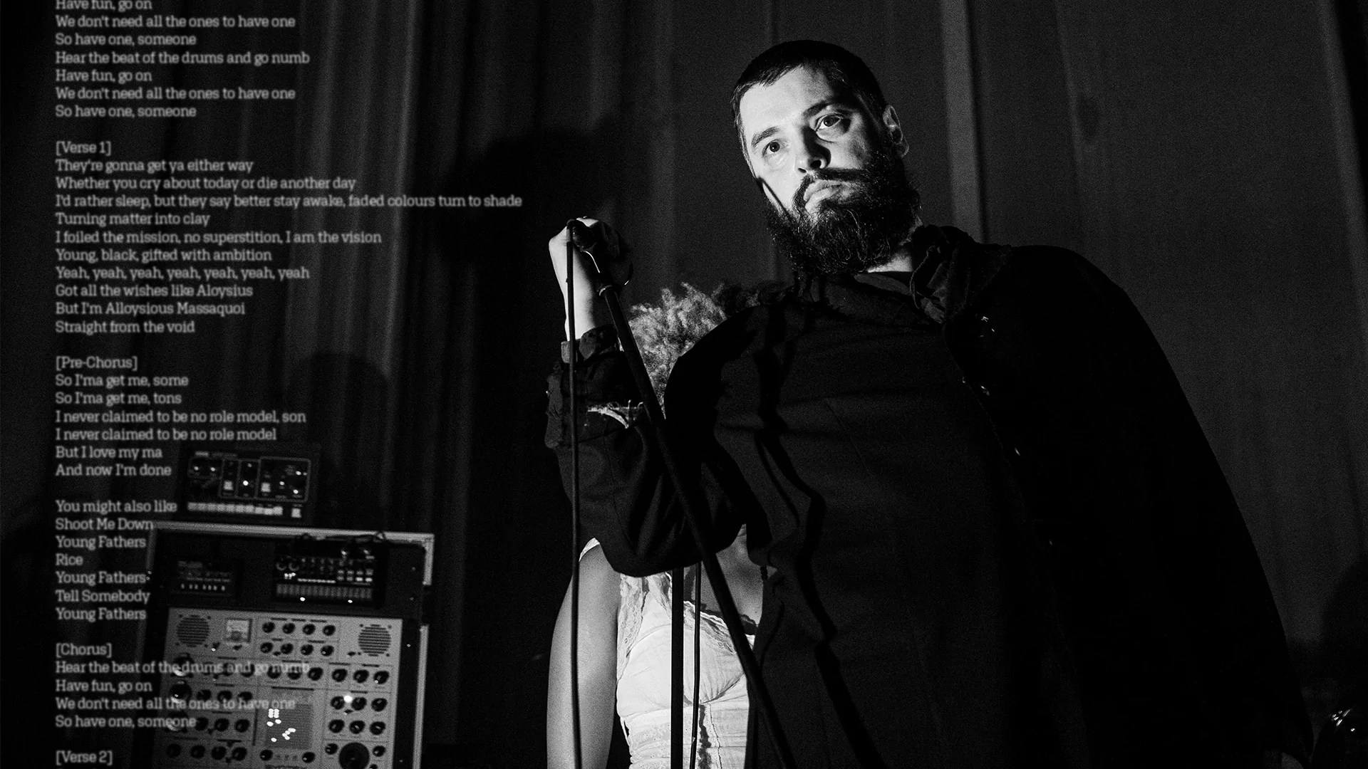 Photo of a man holding a microphone with lyrics spliced on top