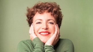 Annie Mac smiling on green background