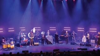 Ensemble of artists affiliated with International Anthem and Total Refreshment Centre performing at the Barbican centre under purple light