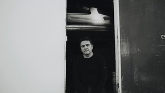 Laurent Garnier is seen standing in a doorway in a black-and-white press shot