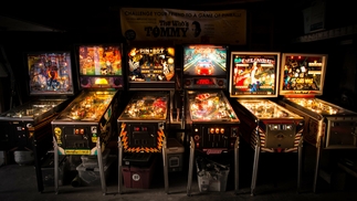 Photo of six vintage pinball machines.