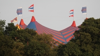 Photo of the tents above the forest skyline at Glastonbury 2023