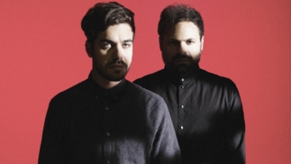 Italian techno duo Tale of Us against a red background