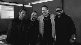 Photo of Tiësto and the three members of Swedish House Mafia smiling with arms around each other