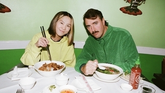 Photo of Demi Riquísimo & Manami eating pho in a green restaurant