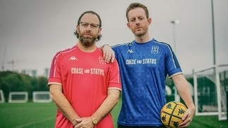 Chase & Status posing in a football field with their Hammersmith FC kit on