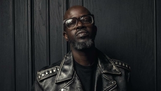 Photo of Black Coffee wearing a leather jacket 