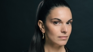 Photo of Cristina Lazic with a slicked-back pony tail against a dark blue background