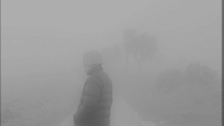 Blurry black and white photo of Plus one standing in fog
