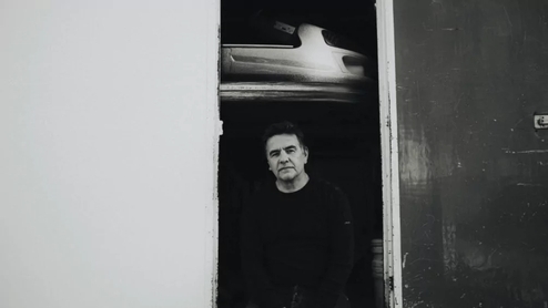 Laurent Garnier is seen standing in a doorway in a black-and-white press shot