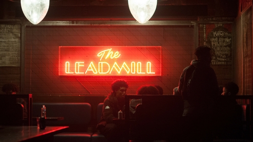 Photo of a red glowing The Leadmill sign inside the venue.