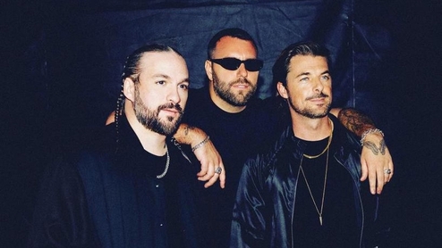 Photo of Steve Angello, Axwell, and Sebastian Ingrosso with the arms around one another