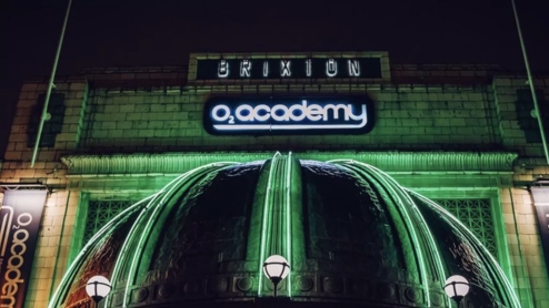 Photo of the front of the Brixton O2 Academy with green lights