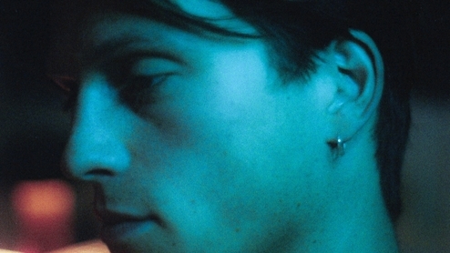 Photo of Jennifur looking sideways in a blue lit room