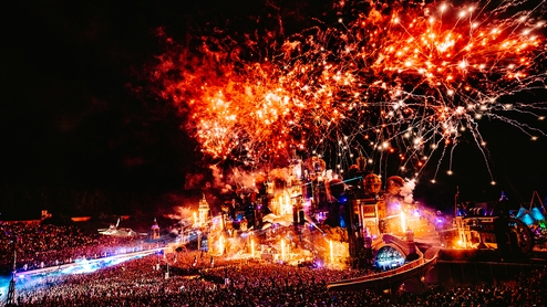 Tomorrowland stage at night with a fireworks display