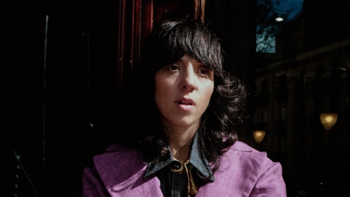 a head shot of Chloe Caillet in a purple suit standing outside