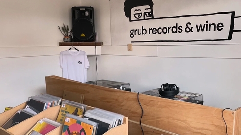 Photo of the inside of Sheffield's Grub Records with record shelves, turntables and speakers
