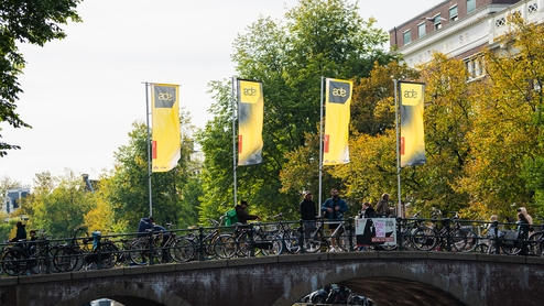 Photo of ADE Flags on a canal bridge in Amsterdam