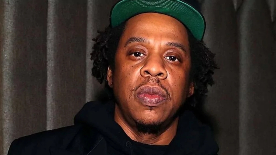 Jay-Z poses in a green baseball cap