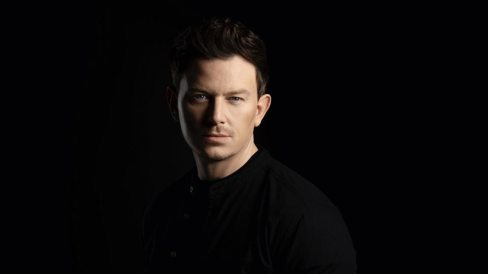 Photo of Fedde Le Grand posing intensely with a black background