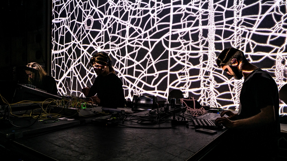 Photo of Klara Lewis, Nik Colk Void, and Pedro Maia mixing at last year’s Conflux Festival