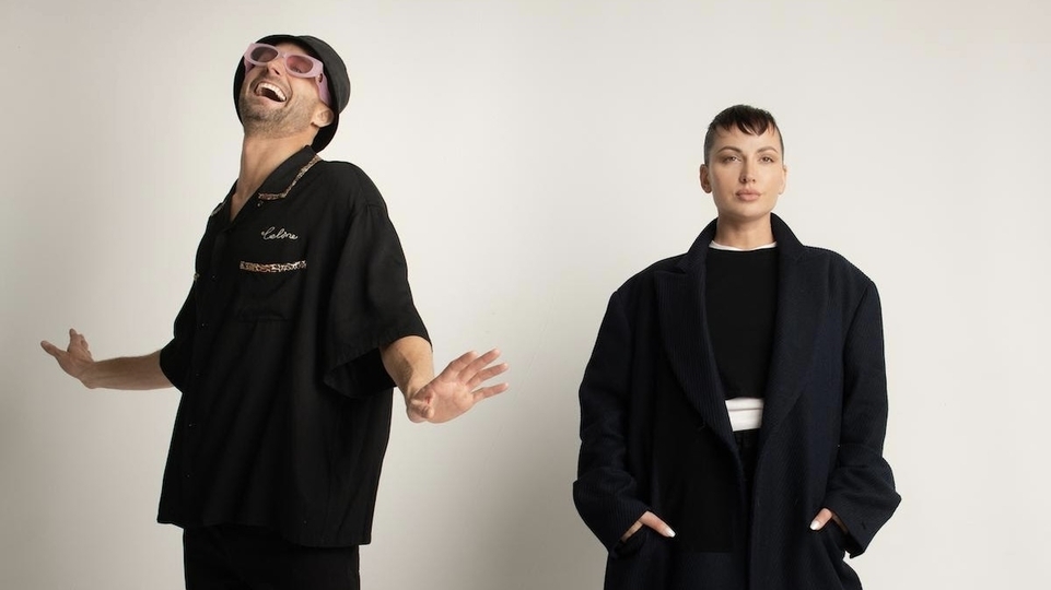 Photo of Fisher and Aatig posing wearing full-black outfits.