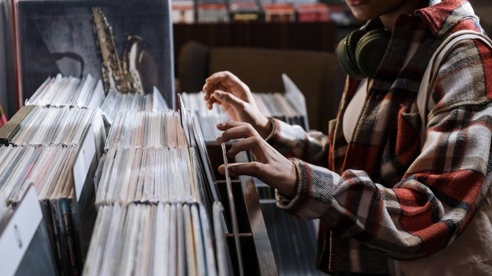 Photo of a person digging through a crate for records