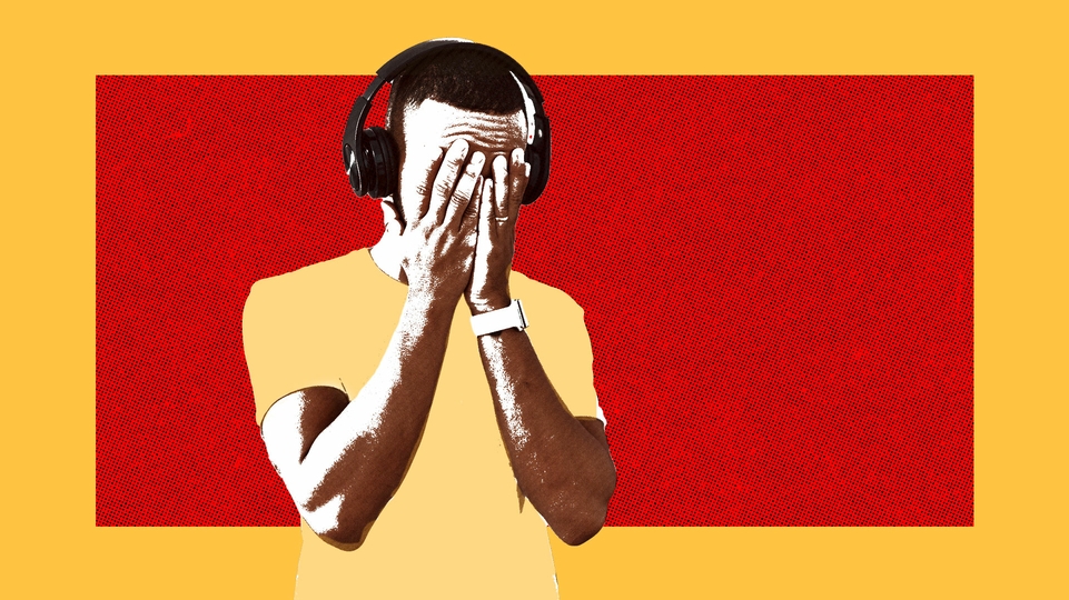 Photo of a man wearing headphones with his head in his hands on a red and yellow pop-art background