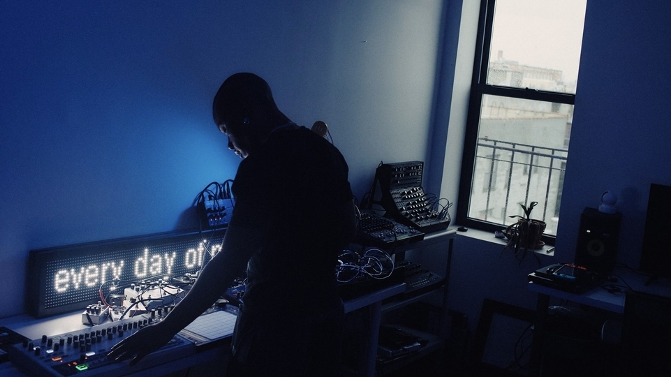 Photo of TYGAPAW DJing in a blue room