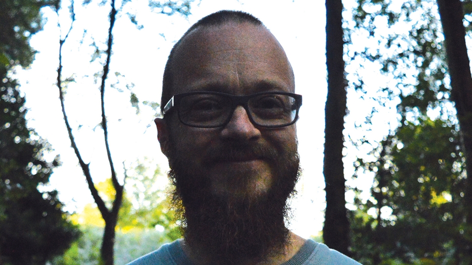 Photo of Necrotype standing in a forest clearing and smiling