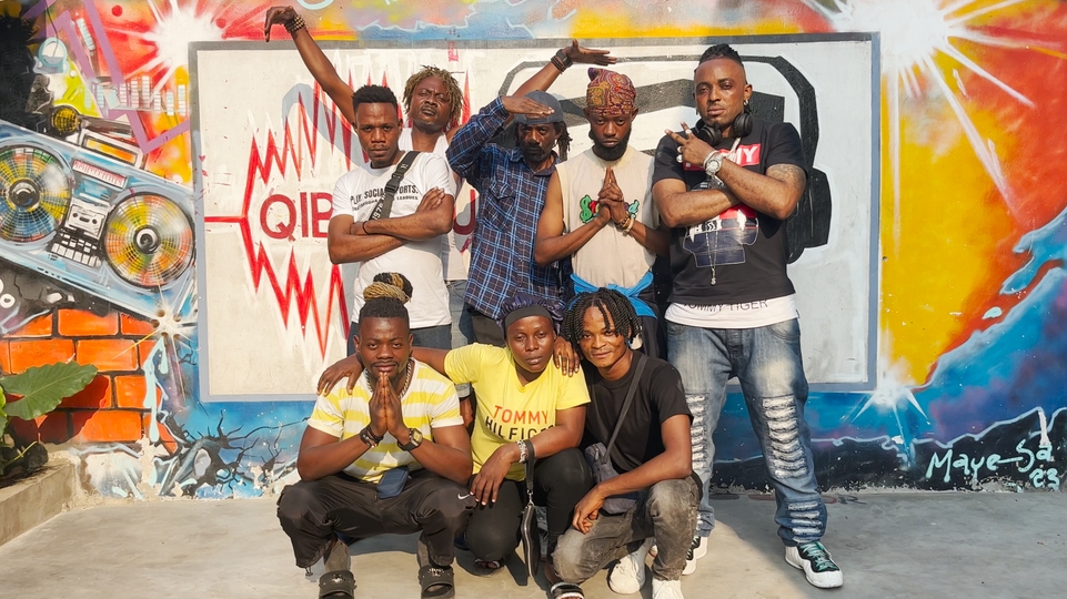 Photo of the members of Ngwaka Son Systéme in front of a colourful wall
