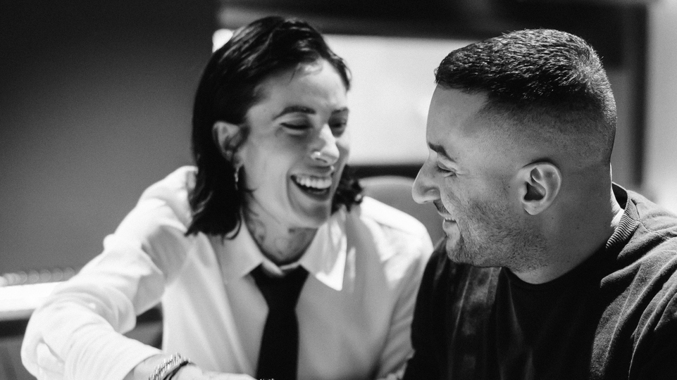 Black and white photo of Indira Paganotto & Joseph Capriati laughing together